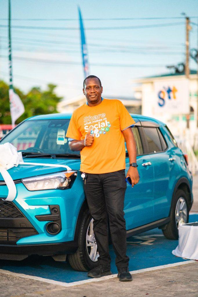 One of the winners, Collace Isaac, is pictured with his new car.