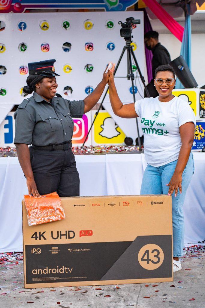 Fire Fighter, Latoya Mc Intosh, receives her prize from Product Marketing Manager of mmg+, Diana Gittens