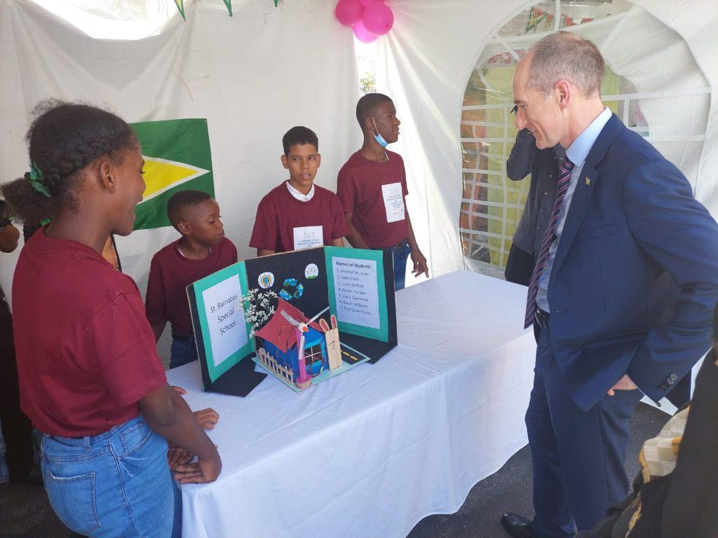 President of ExxonMobil Guyana, Alistair Routledge interacting with students of St. Barnabas Special School at the launched of the Science Technology Engineering and Maths (STEM) Robotics Exhibition for children with disabilities which was held yesterday at Umana Yana.