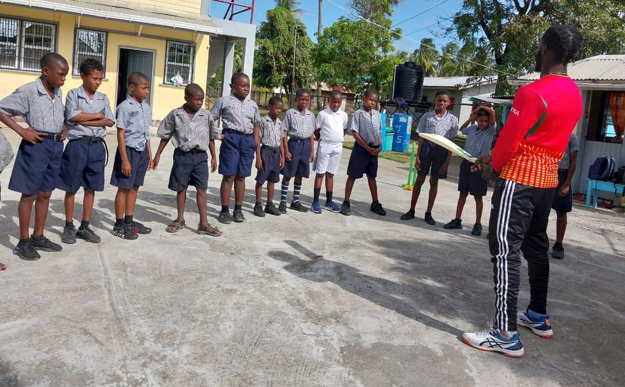 In School Training with a Coach Demonstrating Bat Handling Technique.