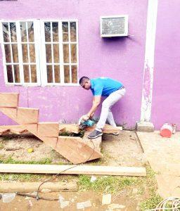 Commander Himnauth Sawh using his skills with an electric saw