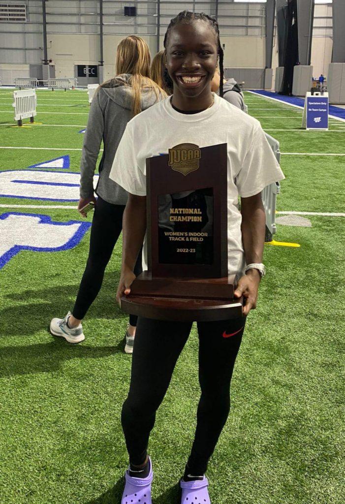 Guyana’s Deshana Skeete is all smiles with the NJCAA Indoor National title trophy.