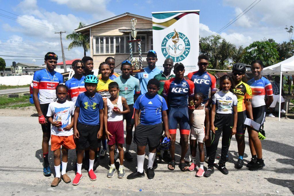 Winners All! The respective category and other winners of the WSUCC ‘One Guyana’ Bartica Cycling Classic pose with their silverware following Sunday afternoon’s presentation.