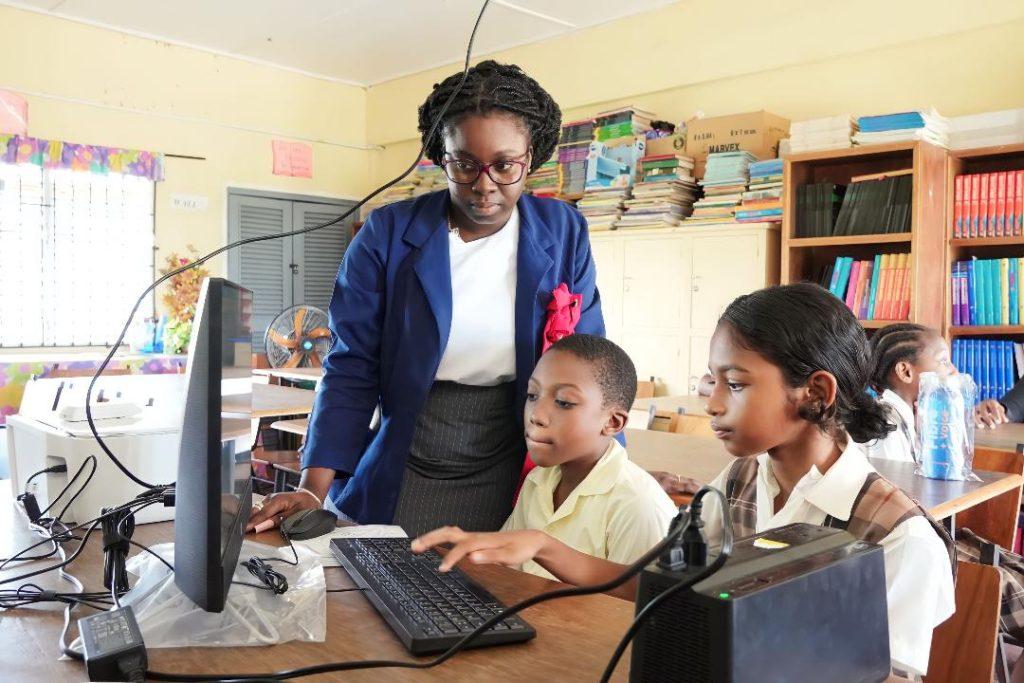 A teacher of the Sophia Primary School instructing pupils during a demonstration