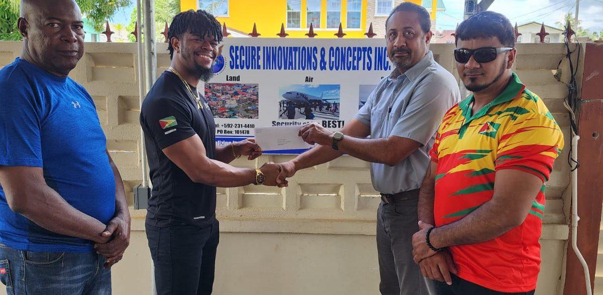 SICInc. Aviation Security Manager, Mr. Denzel Hopkinson (2nd left) hands over the cheque to Captain Dylan Fields in the presence of Lennox Brathwaite (left) and Roberto Tiwari.