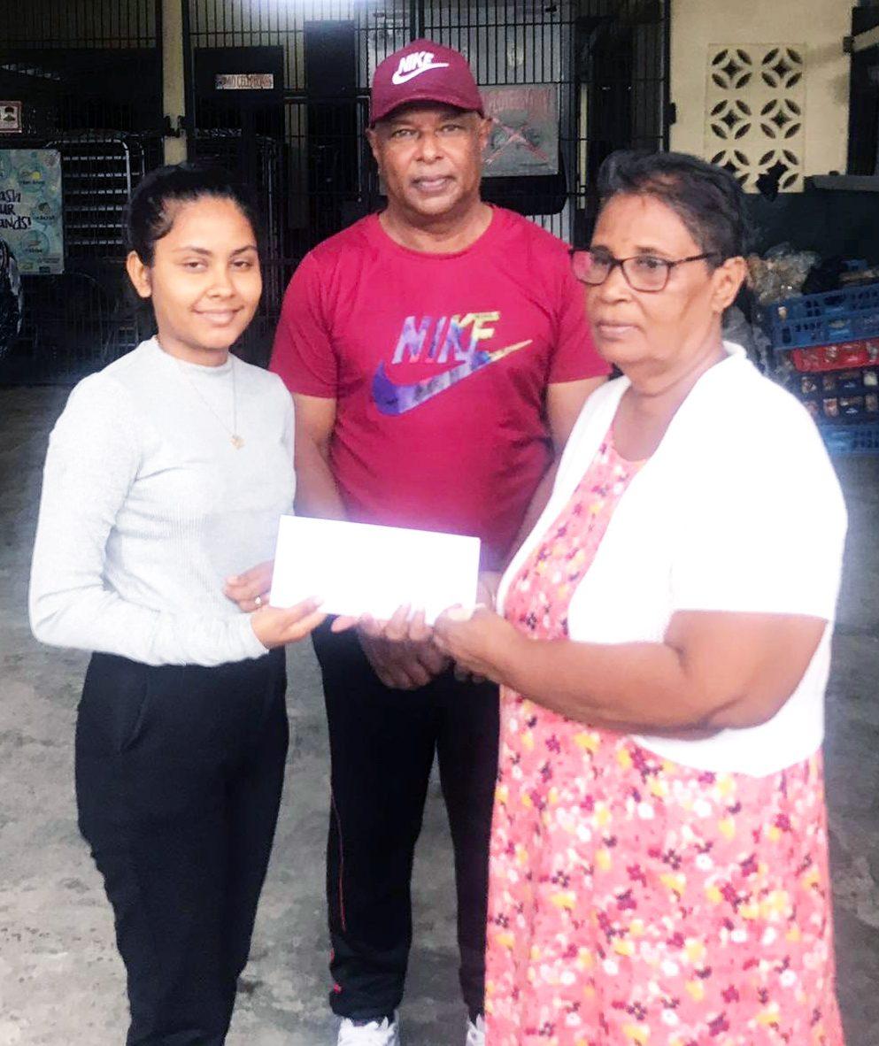 The Secretary of Ali Bakery presents BCB Secretary Angela Haniff and Competition Chairman Leslie Solomon with sponsorship cheque.