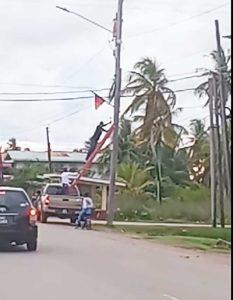 Screengrab from a video of the flags being pulled off the poles at Manchester, Corentyne, Berbice.