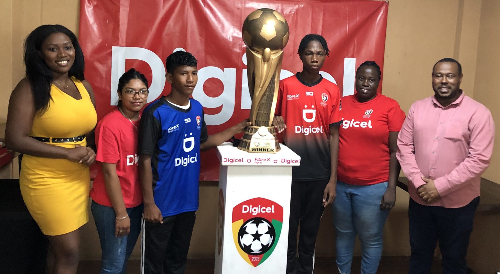 Digicel Communications Officer, Gabrielle Chapman (left), and Petra Co-Director, Troy Medonca, flank the captains and managers of the finalists following yesterday’s briefing.