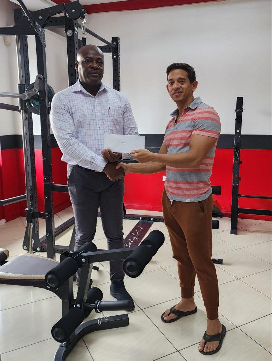 Franklin Wilson (left) accepts the sponsorship from Jamie McDonald of Fitness Express.