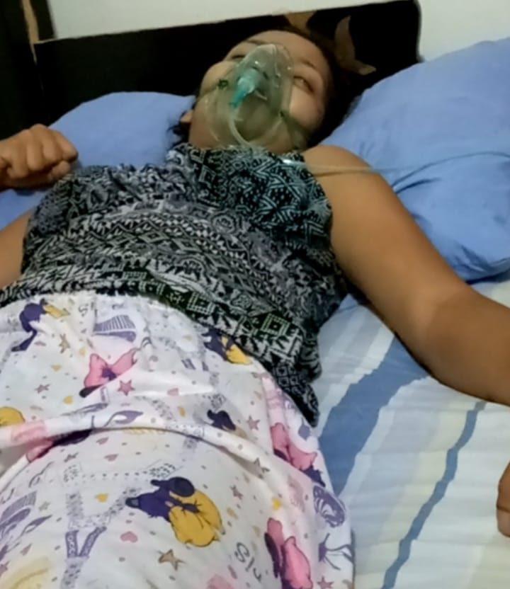 The ailing young woman receiving oxygen at home, during an attack last year