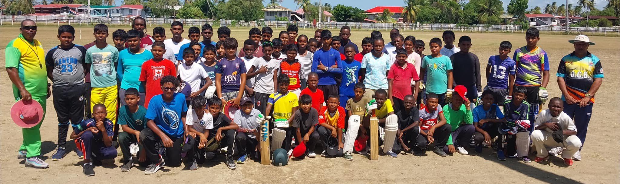 Members of the Dr. Tulsi Dyal Singh Cricket Academy pose with coaches.