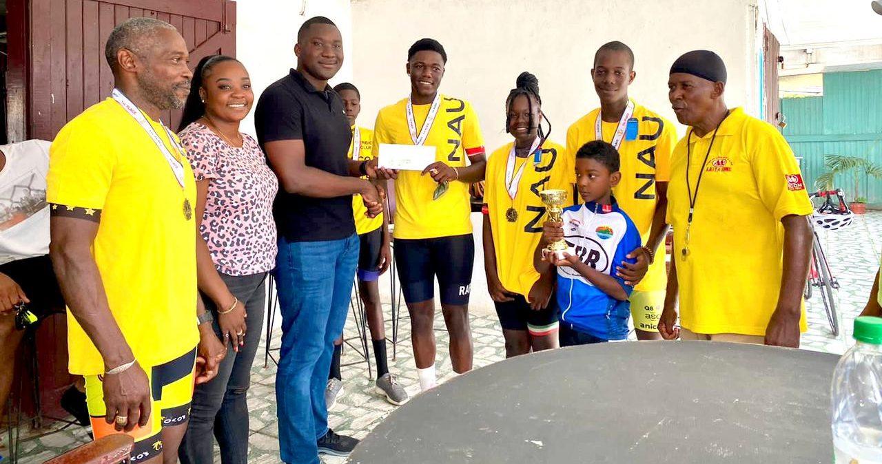 Mikhail Amsterdam and other family members present awards to Romello Crawford and other outstanding riders as Coach Randolph Roberts savours the moment.