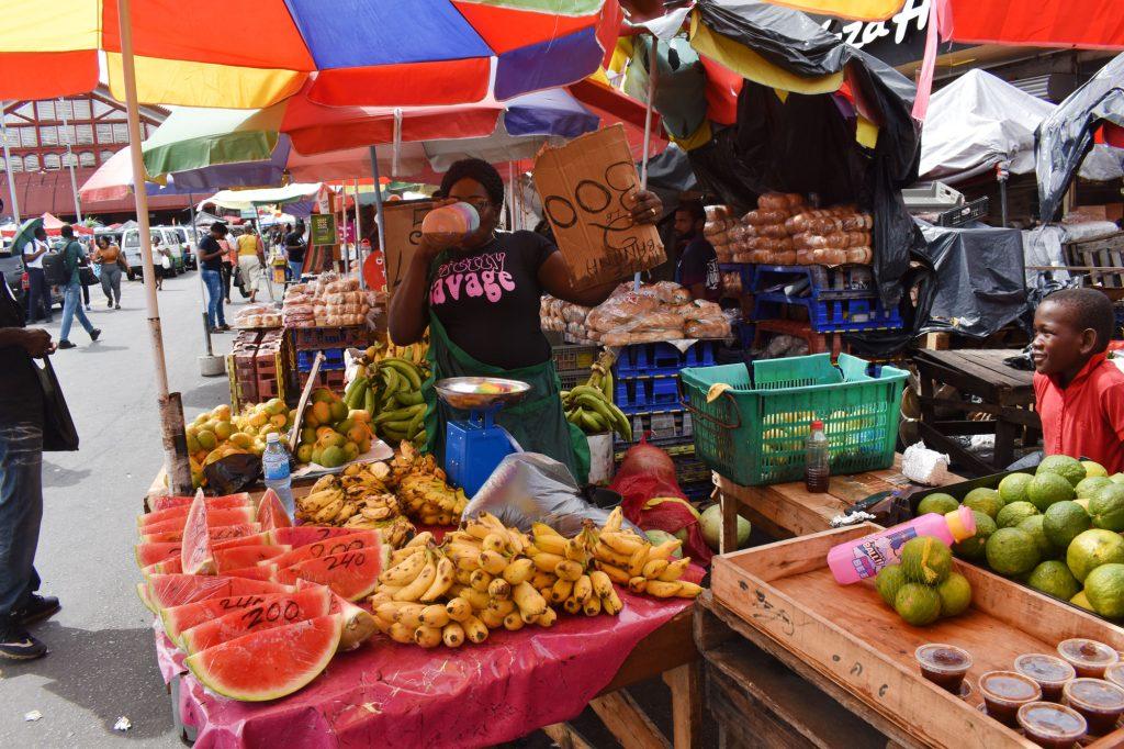 Vendors at Stabroek Market desperately tried to cool themselves with bowls of ice-water and cold drinks. Some used pieces of cardboard as makeshift fans to cool themselves.