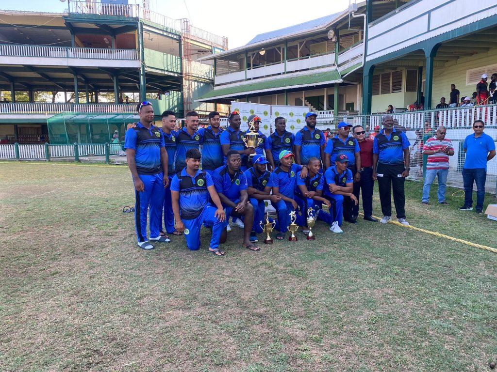 Demerara team pose with coach Gavin Nedd and GCB president Bissoondyal Singh following their GCB Senior Inter-County 50-Over title win against Berbice yesterday at Bourda Ground