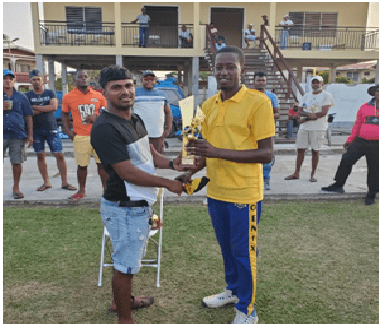 Man of the match - Jamal Gomes receiving his trophy from former Guyana Under15 Batsman Arvin Seepersaud.