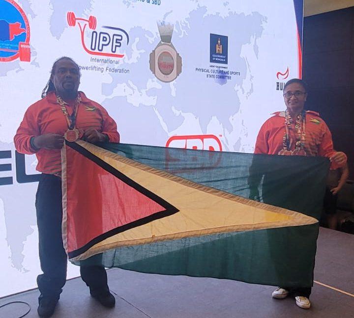 Nadina Taharally (right), and Roger Rogers, displaying the Golden Arrowhead in Mongolia.