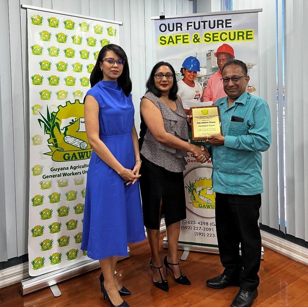 Pauline Chase (right), Serita Chase (middle) receiving the award from GAWU’s President Seepaul Narine (left)