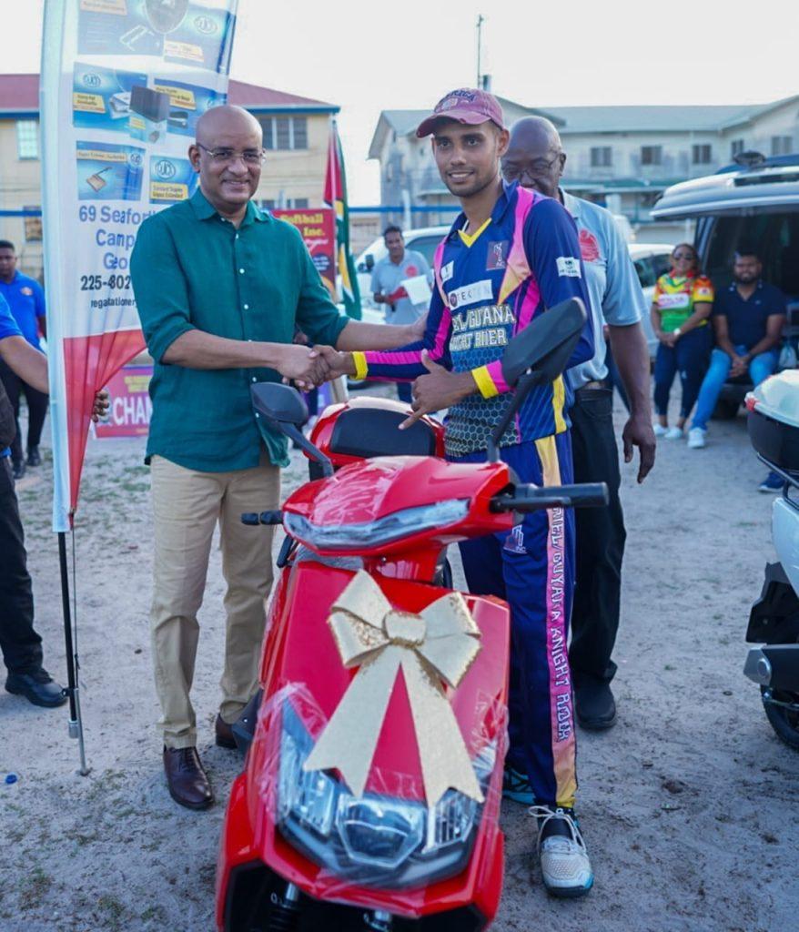 Jonathan Fernandes (R) accepts his MVP prize from Vice President Dr. Bharrat Jagdeo.