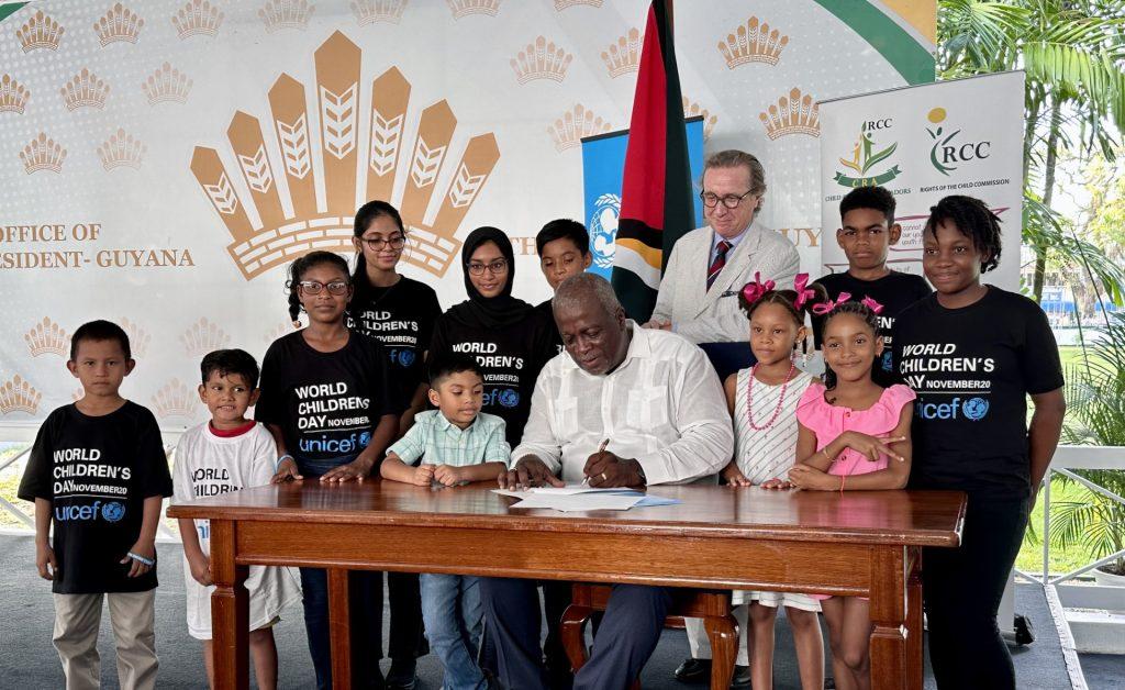 Prime Minister, Mark Phillips joined by Guyanese youth for the signing of the declaration