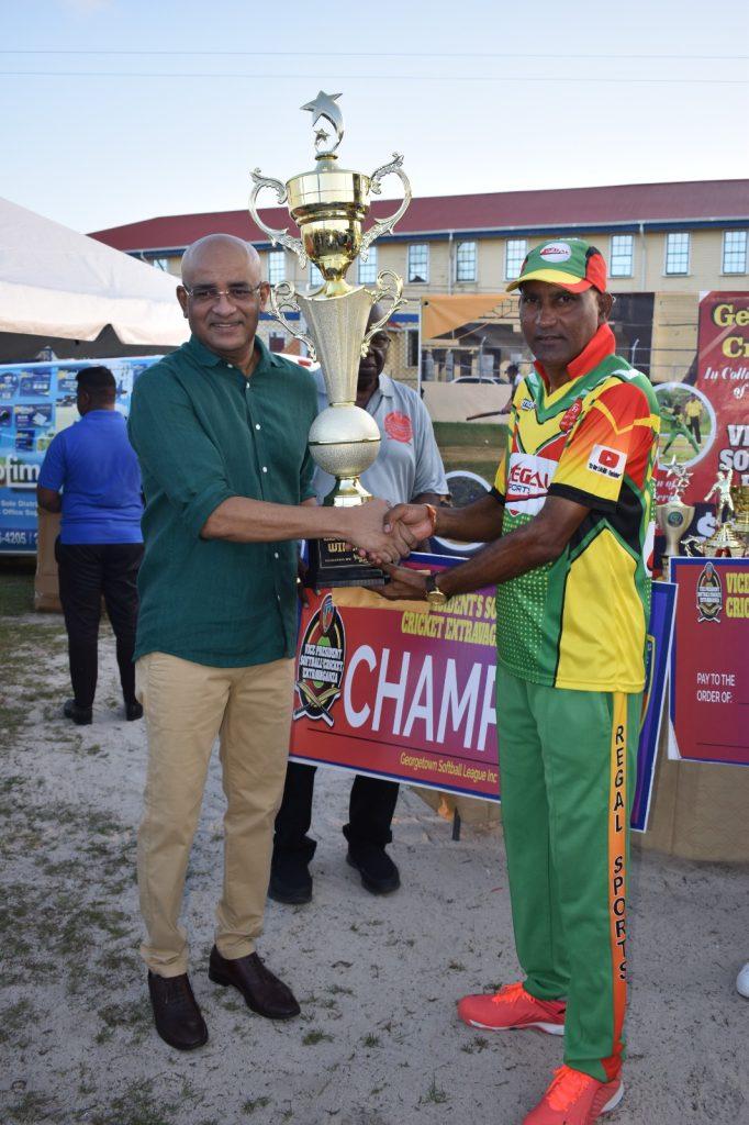 Vice President Dr. Bharrat Jagdeo presents the Over-50 trophy to the victorious Regal Legends skipper Mahendra Anil Hardyal.