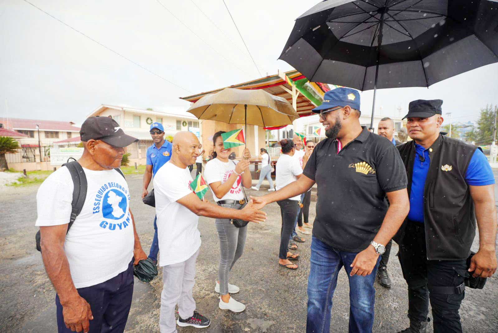 President Irfaan Ali interacts with a resident on the Essequibo Coast on Sunday