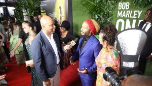 Reggae singer Ziggy Marley (centre), son of late reggae superstar and co-producer of One Love, speaking on the red carpet with ET co-host Kevin Frazier, as Marley’s wife Orly looks on. (Photo: Marlon Reid)