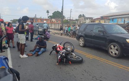 Man carrying baby in arms knocked down by motorbike