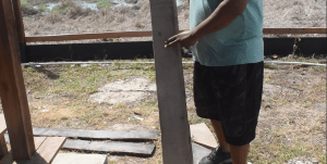 Sahadeo’s Husband, Danny, showing reporters the wood that the bandits used to trash the family’s bus.