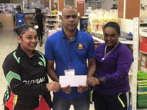 Danny Ramnarine hands over sponsorship to RHTYSC female cricketers Trisha Hardat and Stephanie Ramdas.