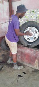 Nickson getting ready to check a tire for holes