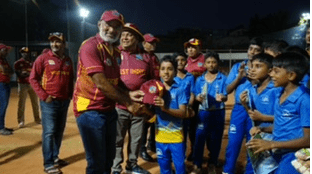 WI skipper Zamin Amin presents a WI cap to another youngster.