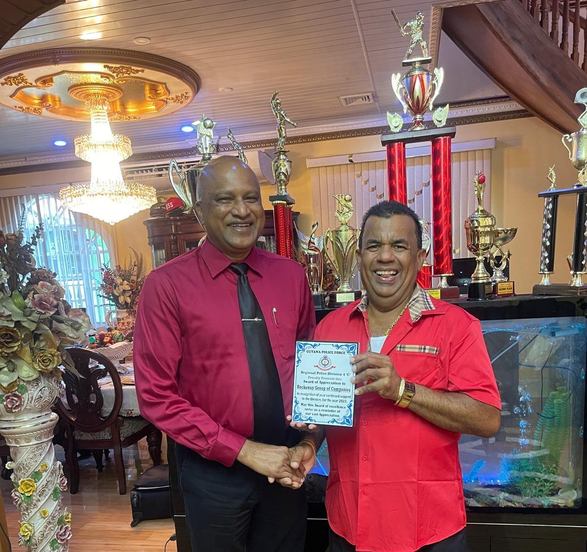 Mr. Seelall Persaud (L) presented the plaque to Mr. Hafeez Ali.