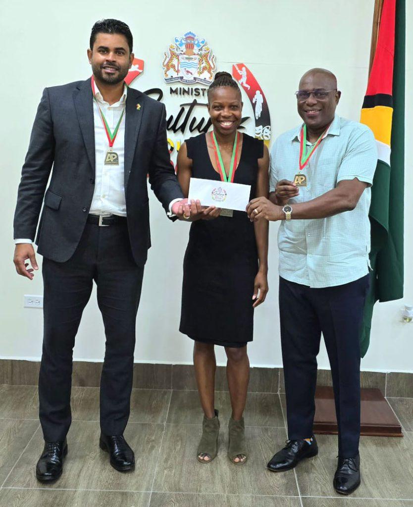 Minister Charles Ramson Jr and Director of Sport Steve Ninvalle make the Government of Guyana’s presentation of $7M to AP Invitational organiser Aliann Pompey.