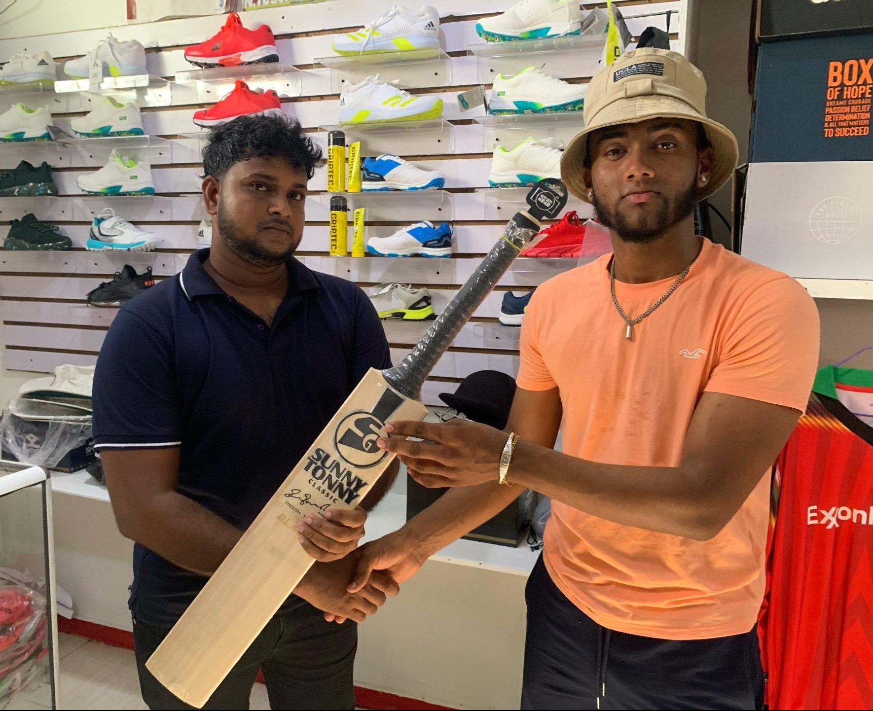 Rampertab Ramnauth receives his newly purchased bat from Cricnation592 Store, compliments of Kascon Engineering.