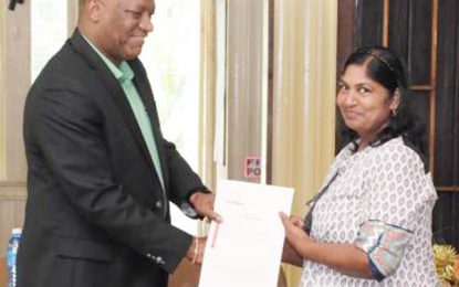 Region Ten residents receive land titles after 25-year long wait