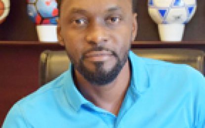 Director of Sport Christopher Jones congratulates Guyanese