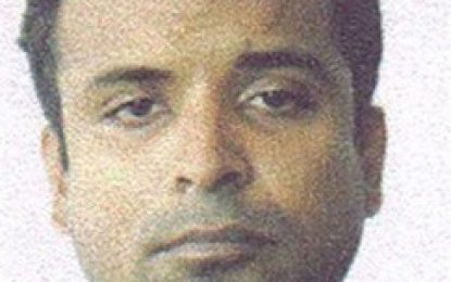 Roger Khan remains in custody after returning