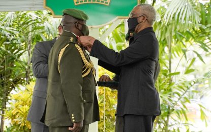 Pres Granger presents Brig. Godfrey Bess with Instruments of Commission