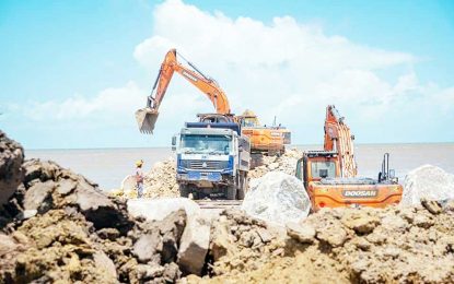 Minister Edghill stresses timely completion during visit to Region Five sea defence works