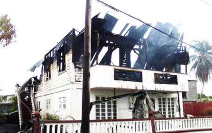 Five homeless after two story building goes up in flames