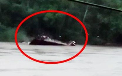 Barge with fuel sinks in Cuyuni River