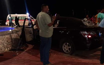 Three injured after car crashes into roundabout