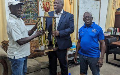 Prime Minister presents champion’s trophy for birth anniversary dominoes tourney to organisers