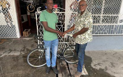 Sandy presented with racing bike to prepare ahead of Caribbean Junior Championships in Barbados
