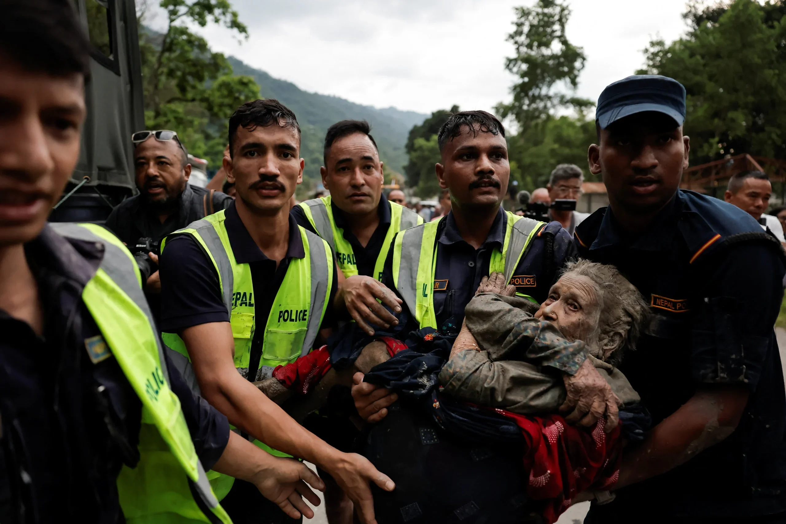 Rescuers retrieve flood survivors caked in mud as death toll in Nepal-China border disaster climbs